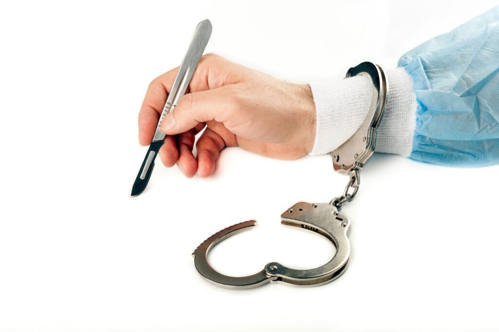 Doctor Holding Scalpel in Hand With Handcuff On